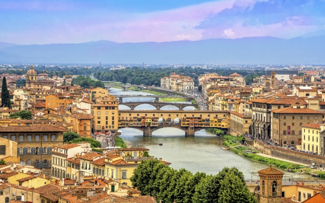 Aerial view of medieval stone bridge Ponte Vecchio over Arno river in Florence, Tuscany, Italy. Florence cityscape. Florence architecture and landmark.
