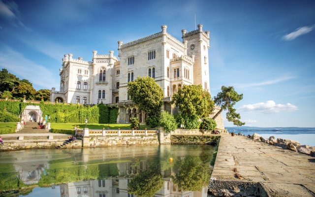 View on Miramare castle on the gulf of Trieste on northeastern Italy. Long exposure image technic with reflection on the water